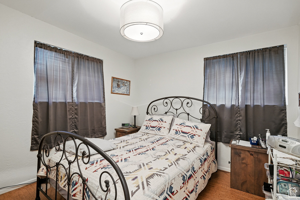 Bedroom featuring wood finished floors and baseboards