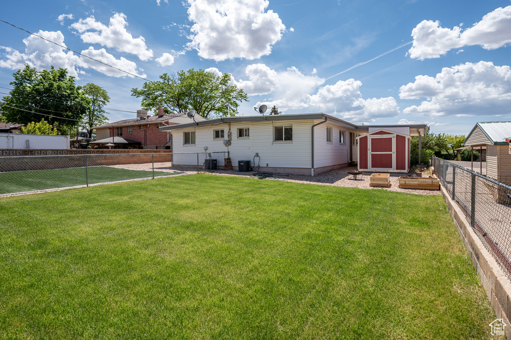 Rear view of property with central AC unit