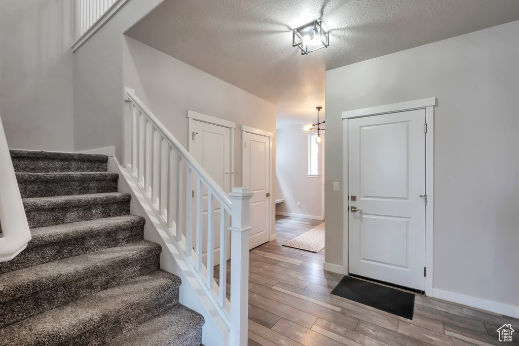 Stairs featuring wood finished floors and baseboards