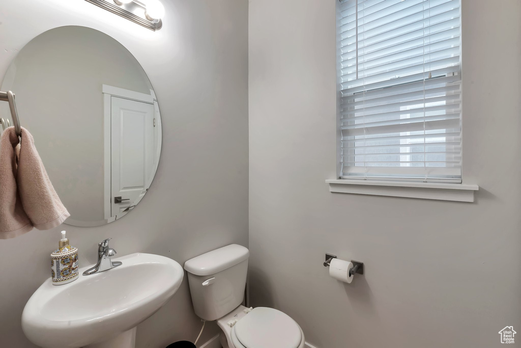 Half bath featuring a sink and toilet