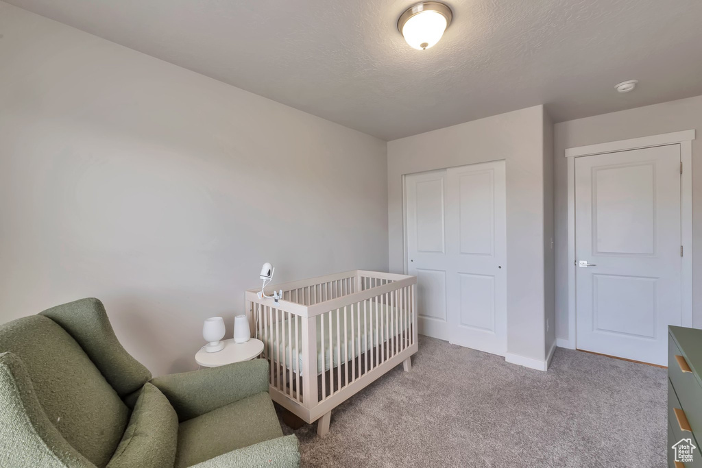 Bedroom featuring carpet, a closet, and baseboards