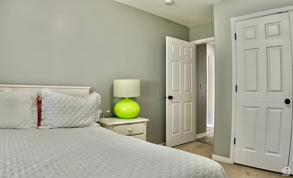 Bedroom with light carpet and baseboards