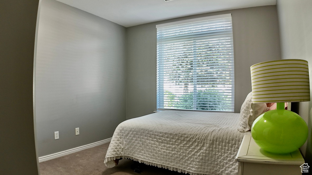 Carpeted bedroom featuring baseboards