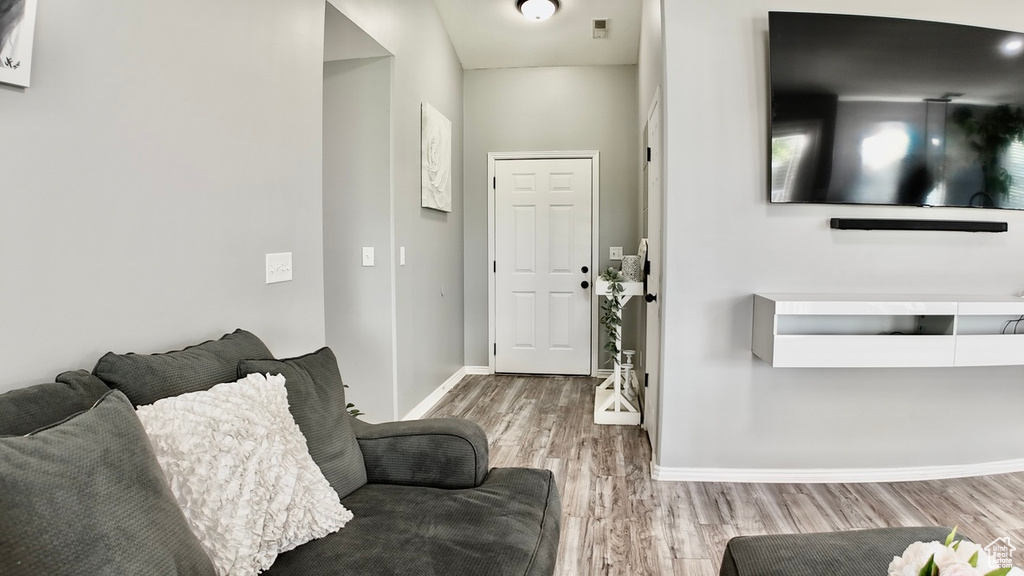 Living area with wood finished floors and baseboards