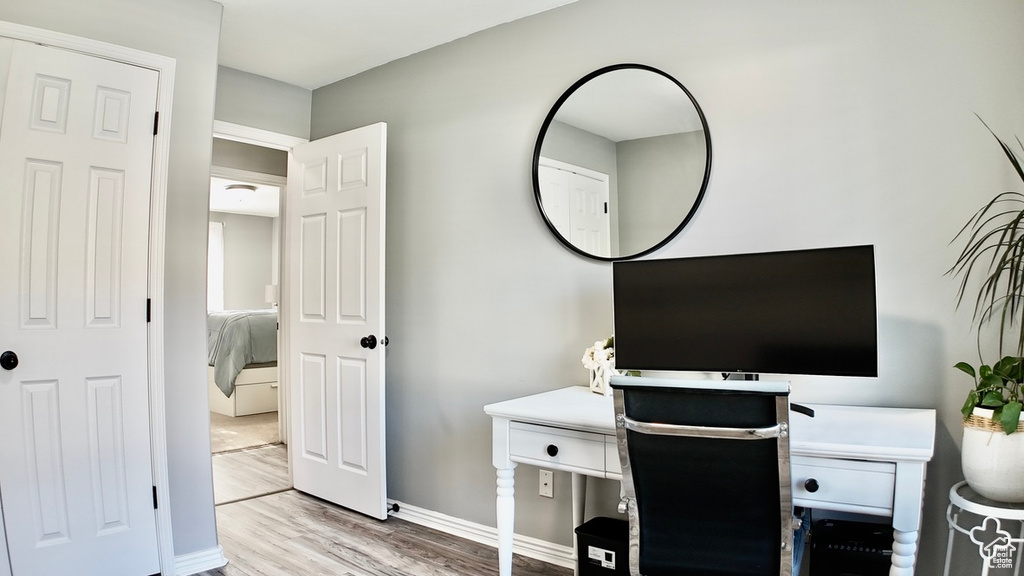 Office space with wood finished floors and baseboards