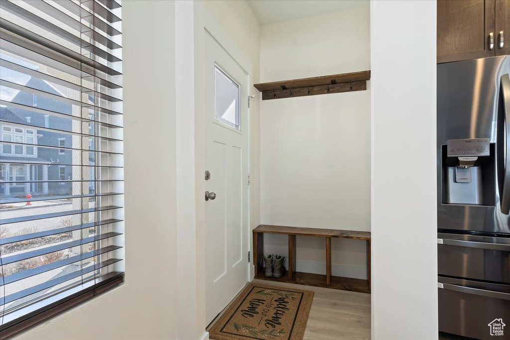 Mudroom with light wood-style floors and baseboards