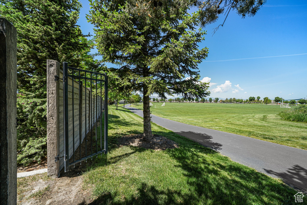 View of asphalt road with a gated entry