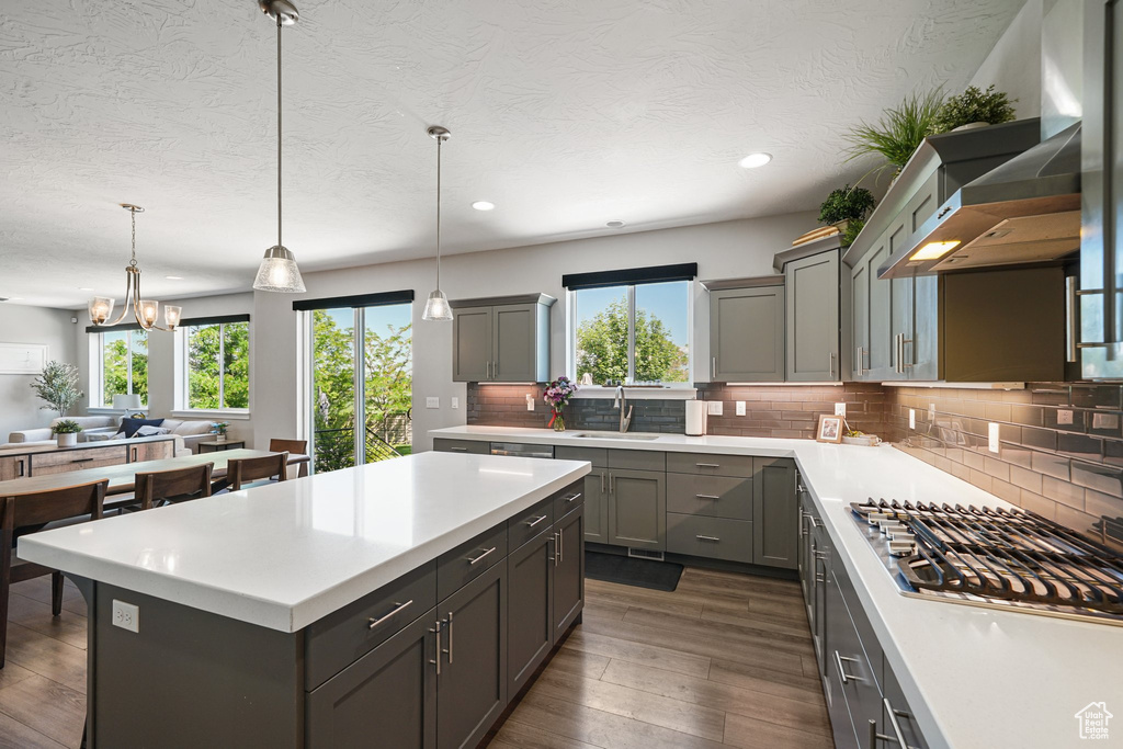 Kitchen featuring stainless steel gas stovetop, healthy amount of natural light, light countertops, recessed lighting, and a textured ceiling
