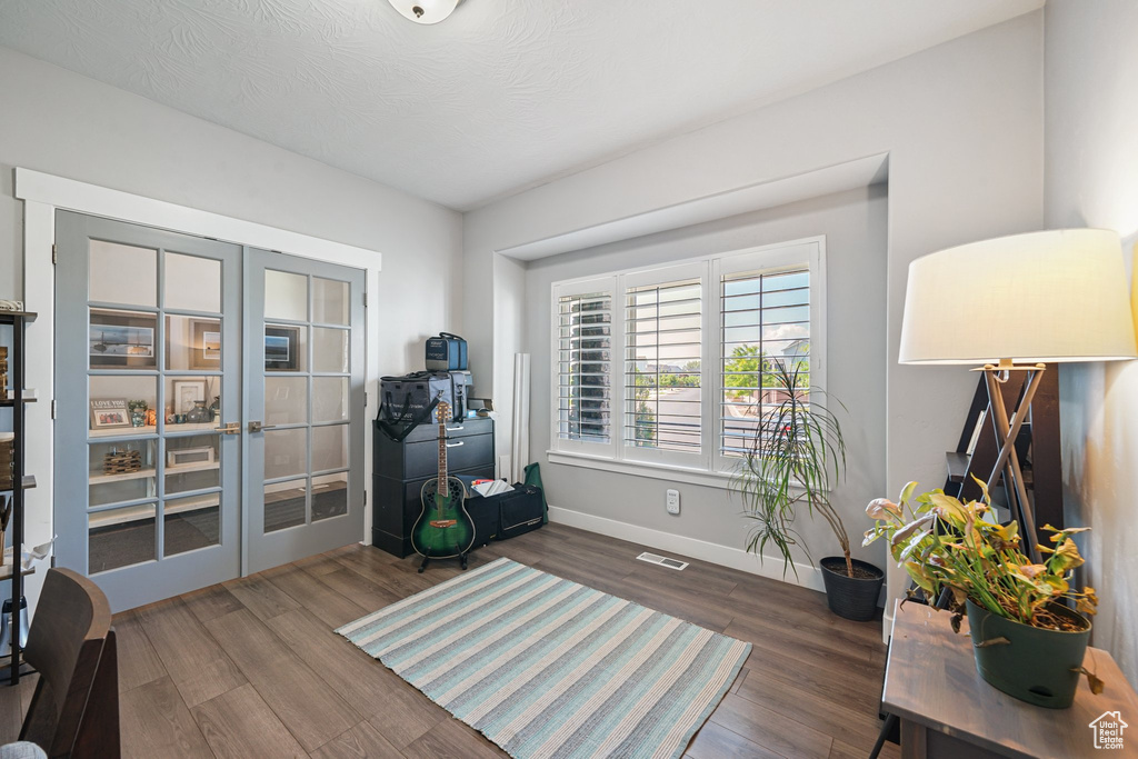 Sitting room featuring french doors, wood finished floors, and baseboards