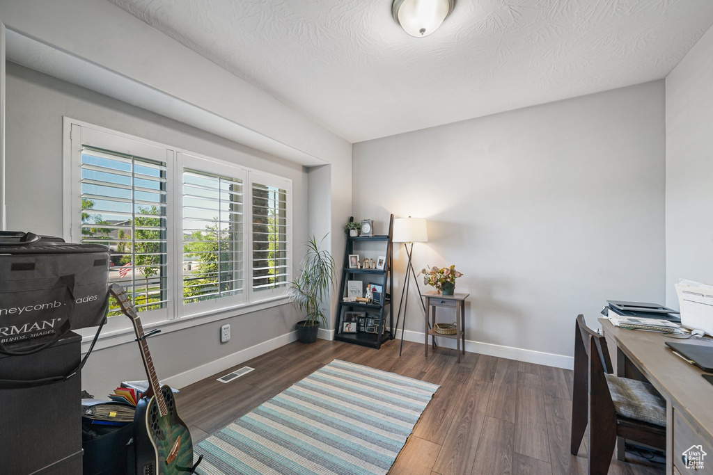 Office space with baseboards and wood finished floors