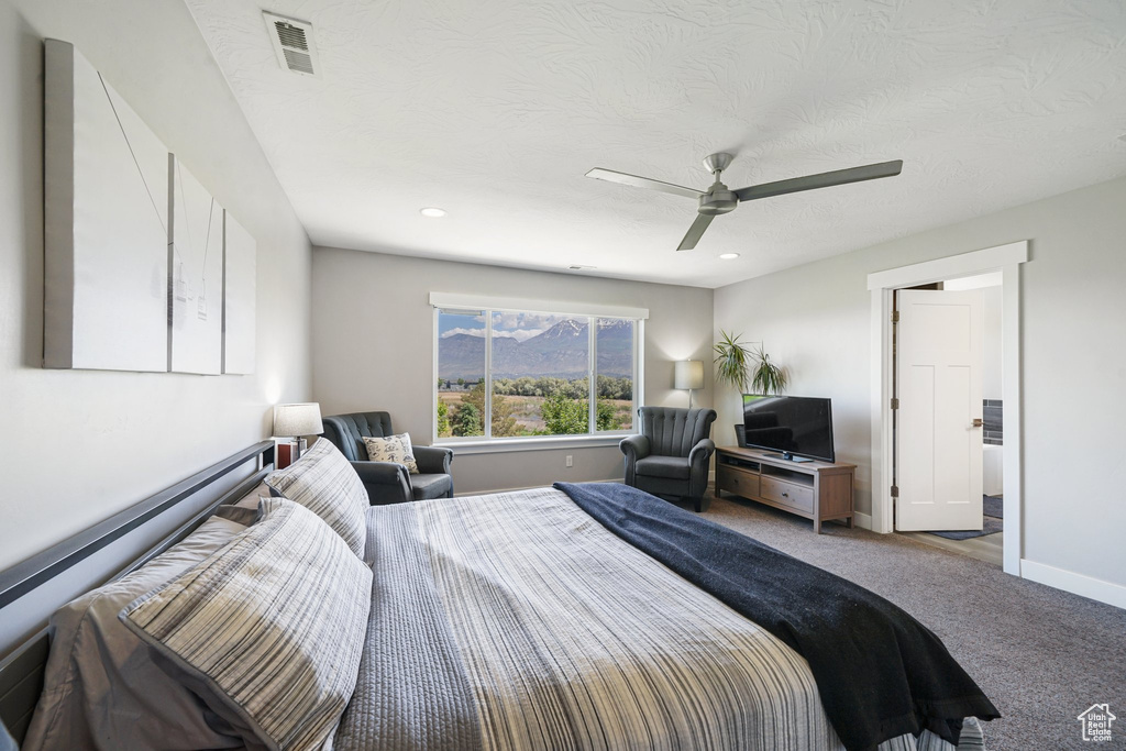 Carpeted bedroom featuring a ceiling fan, baseboards, recessed lighting, and a textured ceiling
