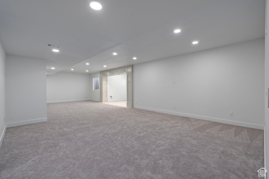 Finished basement featuring recessed lighting, baseboards, and light carpet