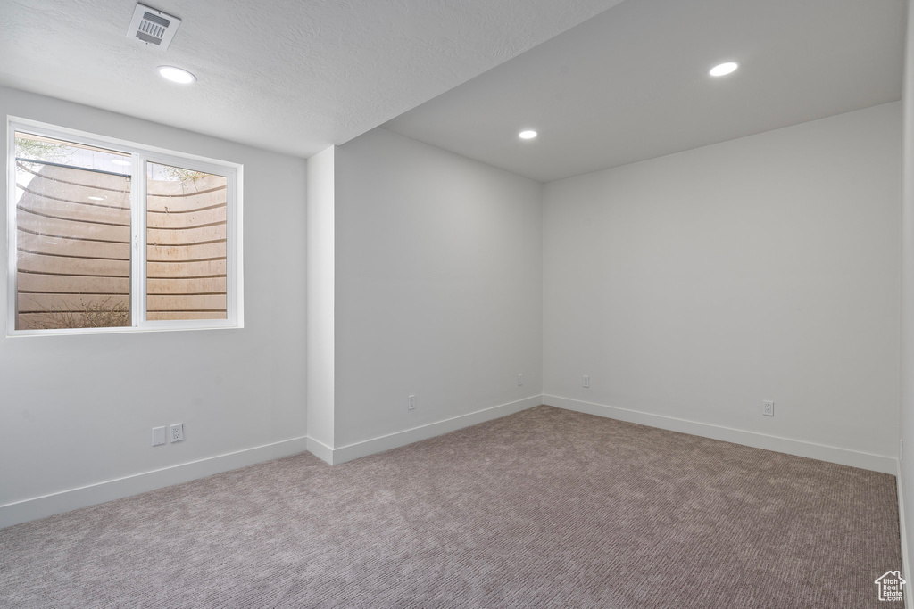 Empty room with carpet, baseboards, and recessed lighting