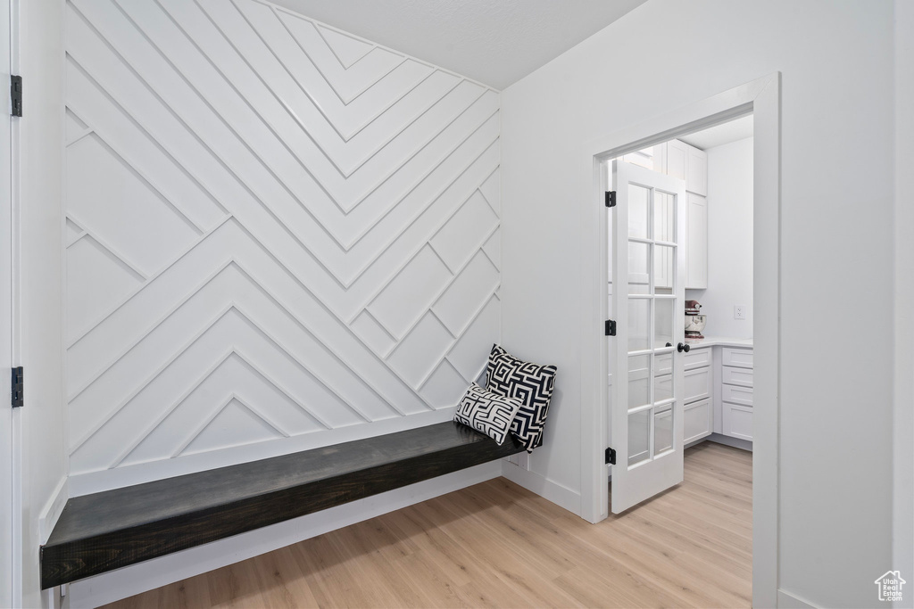 Corridor featuring light wood-style flooring and baseboards