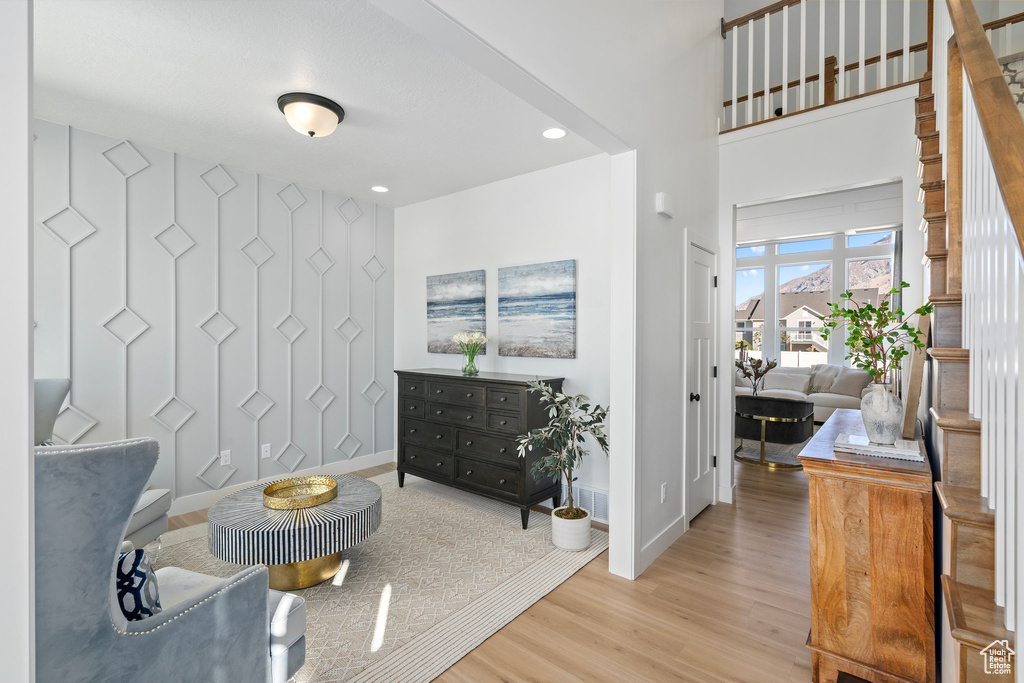 Living area featuring wood finished floors, baseboards, and recessed lighting