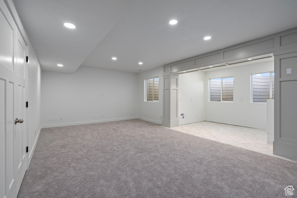 Basement featuring recessed lighting, light colored carpet, and baseboards