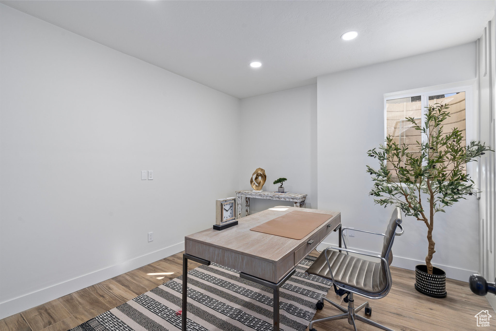 Office space featuring baseboards, wood finished floors, and recessed lighting
