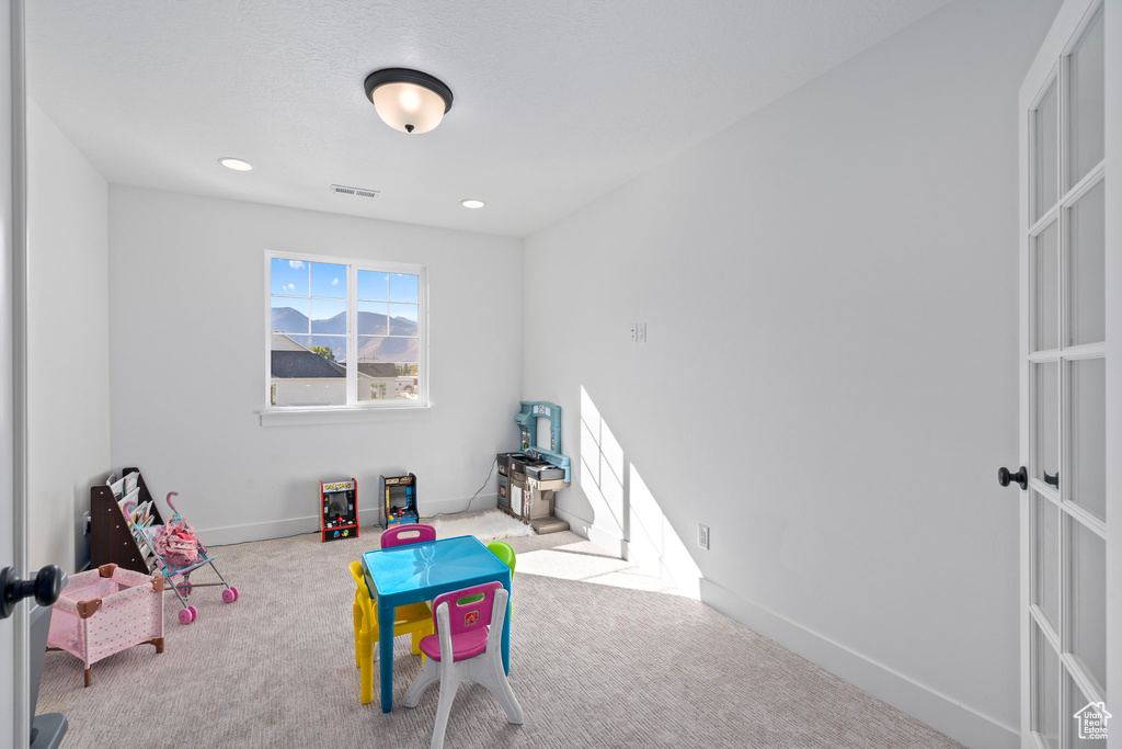 Playroom featuring carpet flooring, baseboards, and recessed lighting