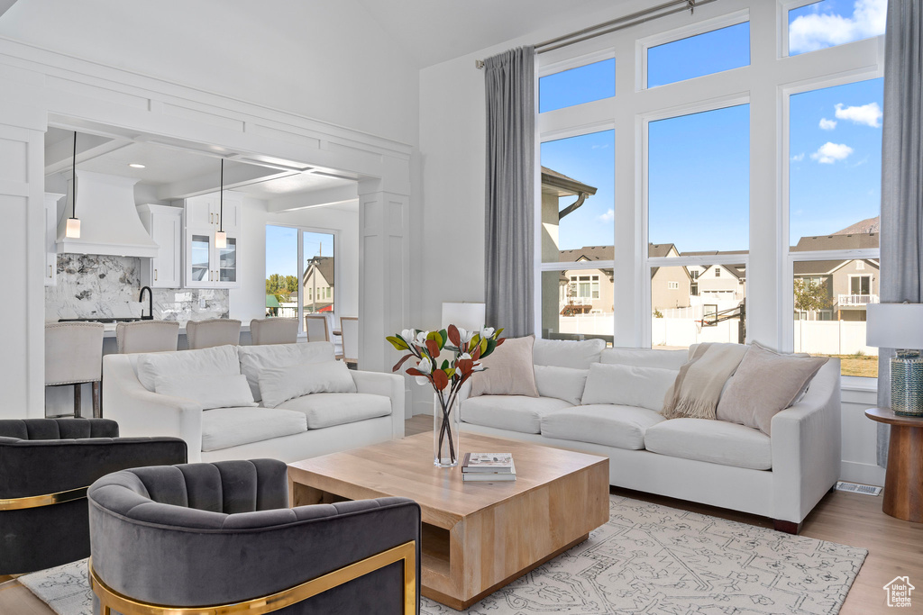 Living area featuring plenty of natural light and light wood-style floors