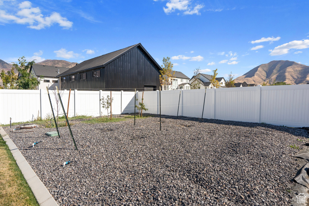 Fenced backyard featuring a mountain view