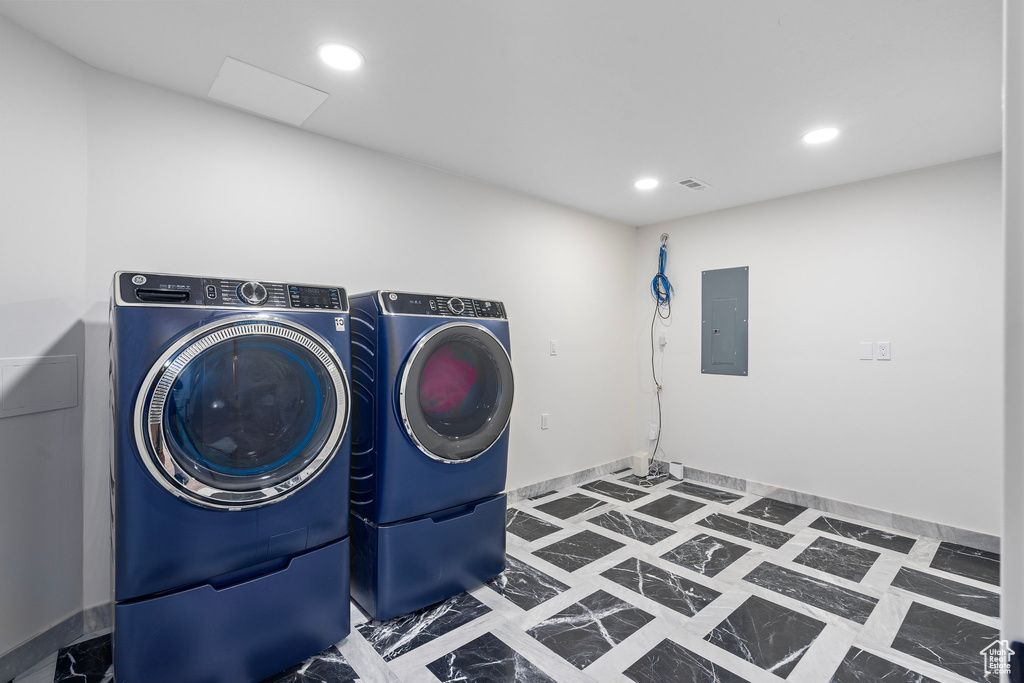 Laundry area with separate washer and dryer, electric panel, and recessed lighting