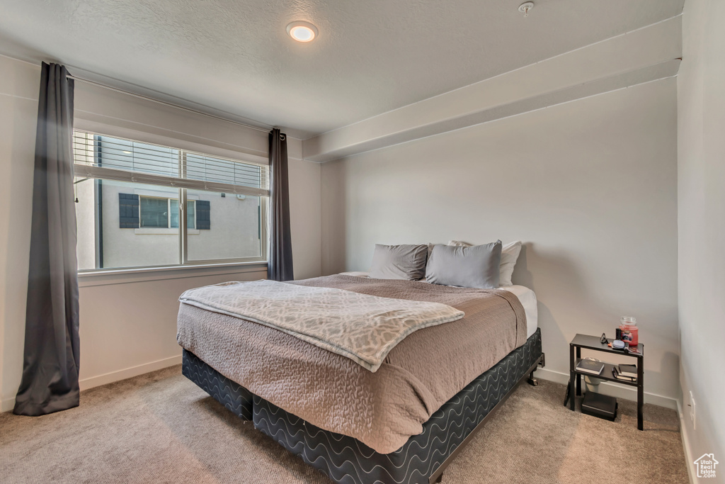 Carpeted bedroom with baseboards