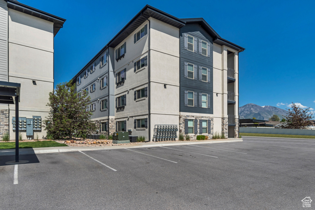 View of property featuring uncovered parking and a mountain view