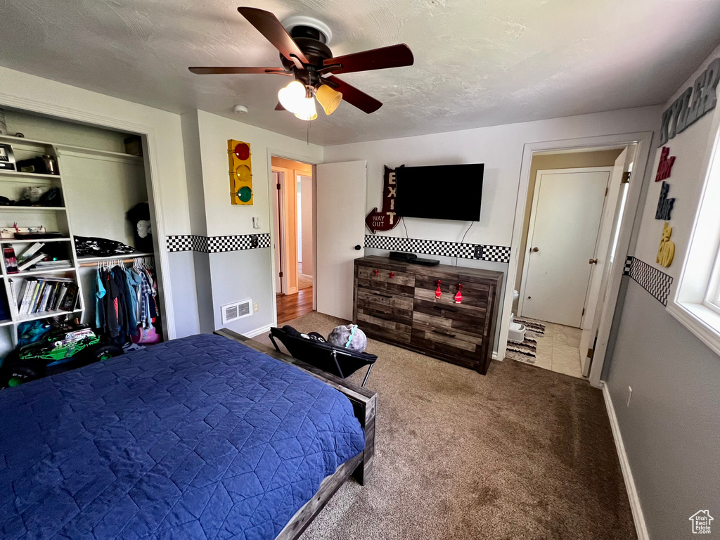 Bedroom featuring a ceiling fan, carpet, a closet, and baseboards