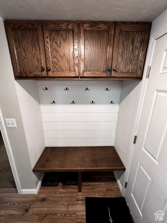 Mudroom featuring wood finished floors and baseboards