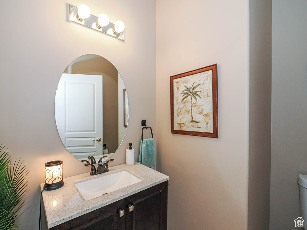 Half bath featuring vanity and toilet