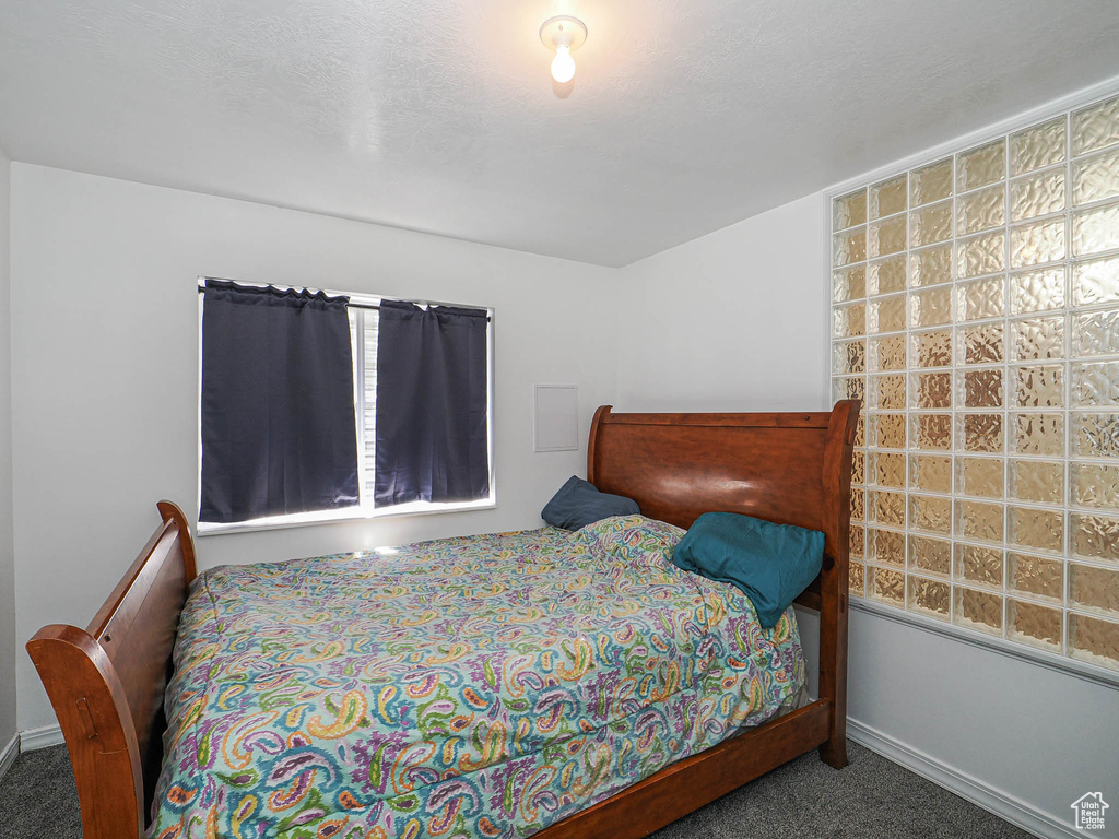 Carpeted bedroom with baseboards