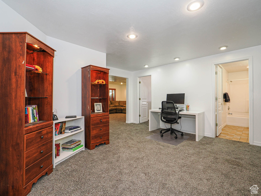 Carpeted office space featuring recessed lighting