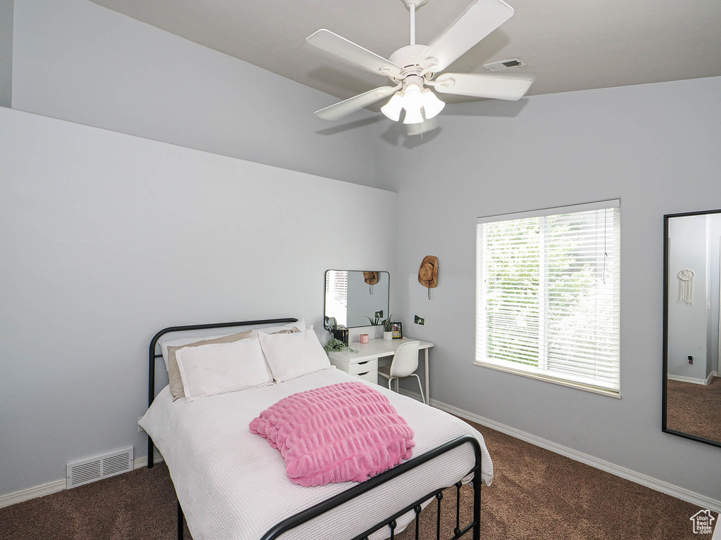 Carpeted bedroom with baseboards and a ceiling fan