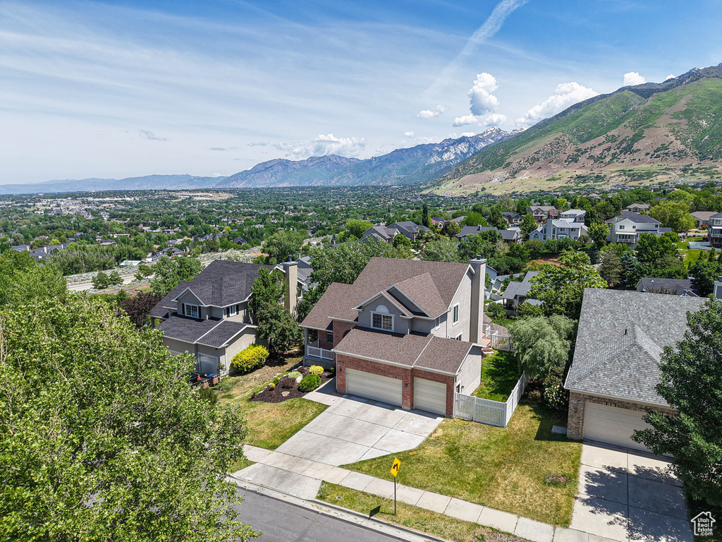 Aerial view of residential area featuring a mountainous background