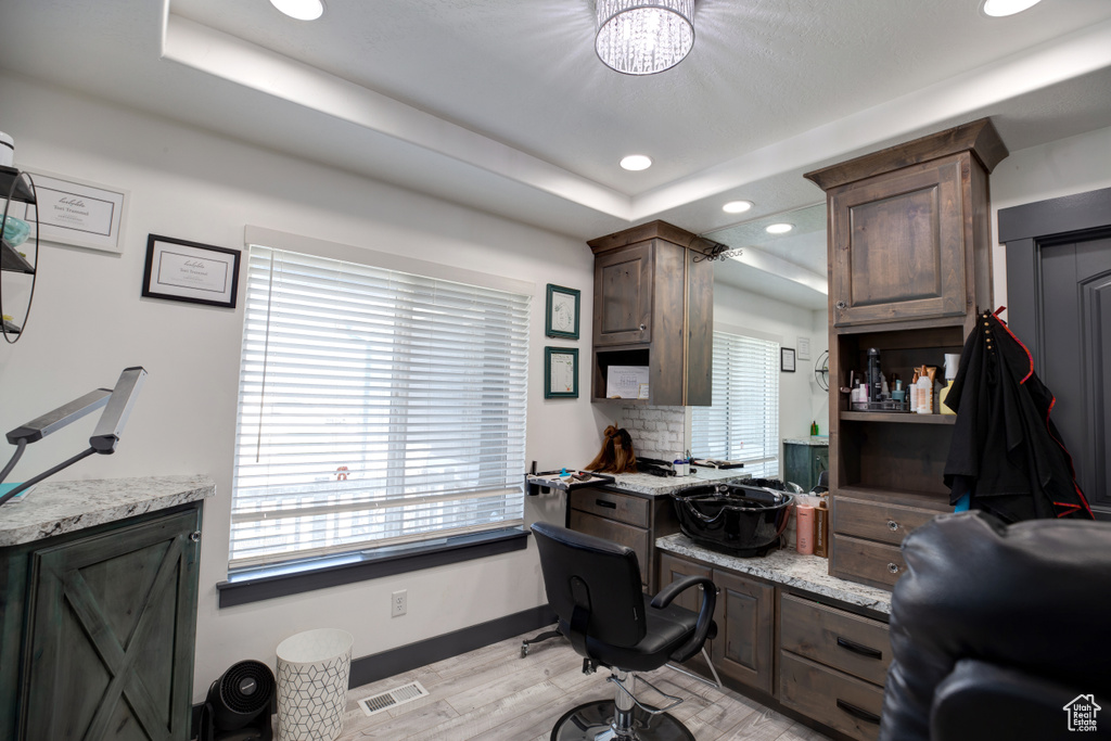 Office with recessed lighting, light wood-type flooring, baseboards, a chandelier, and a raised ceiling