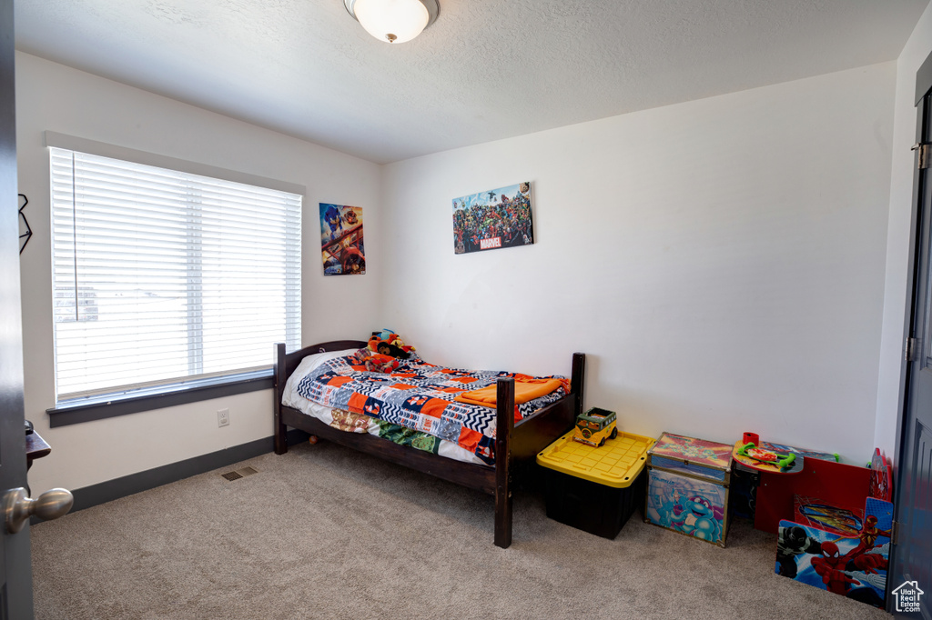 Carpeted bedroom featuring baseboards