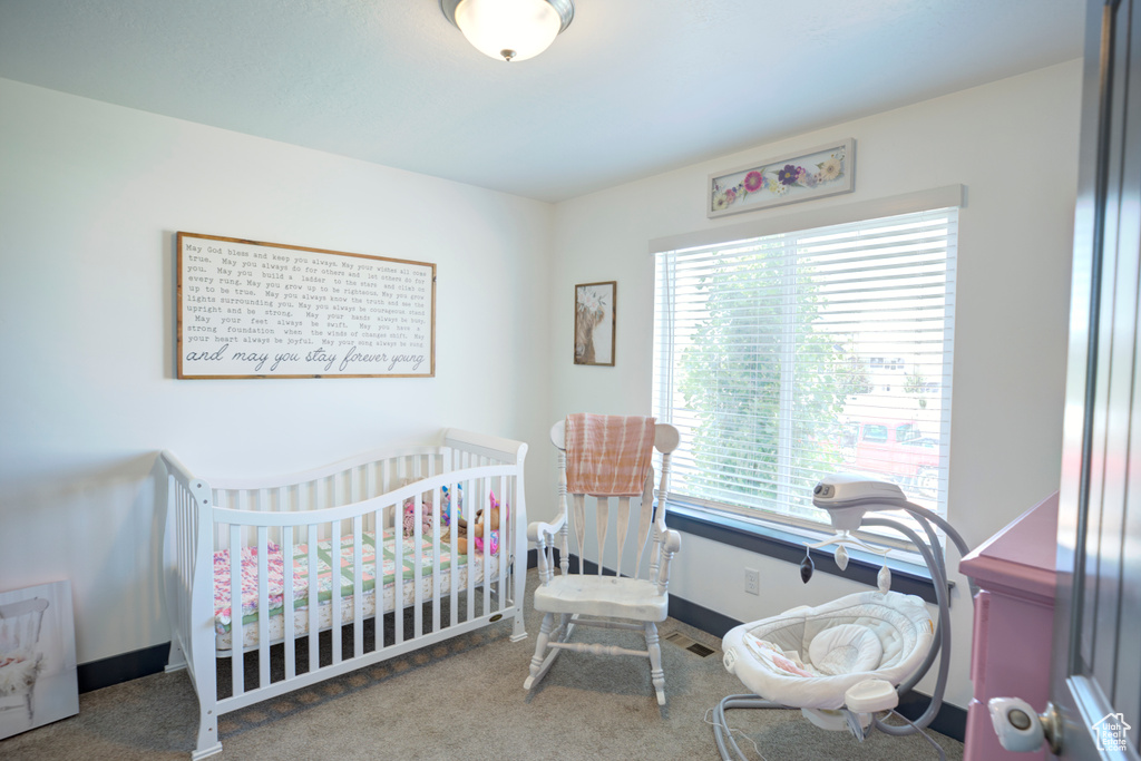 Bedroom with carpet flooring and baseboards