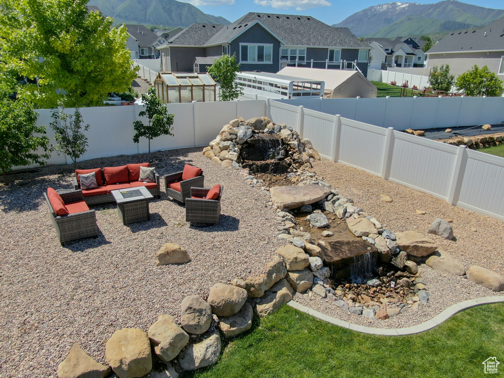 Fenced backyard with a mountain view, a residential view, and outdoor lounge area