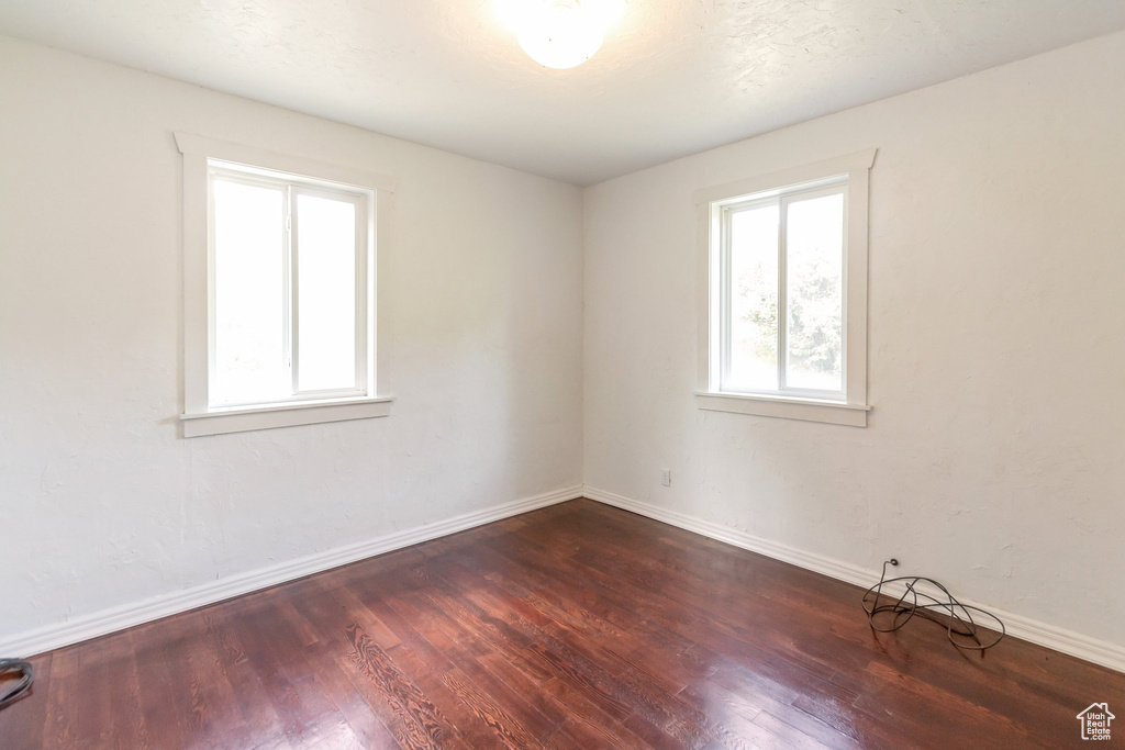 Empty room featuring wood finished floors and baseboards