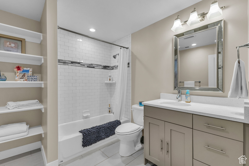 Bathroom with vanity, shower / tub combo with curtain, tile patterned floors, toilet, and recessed lighting