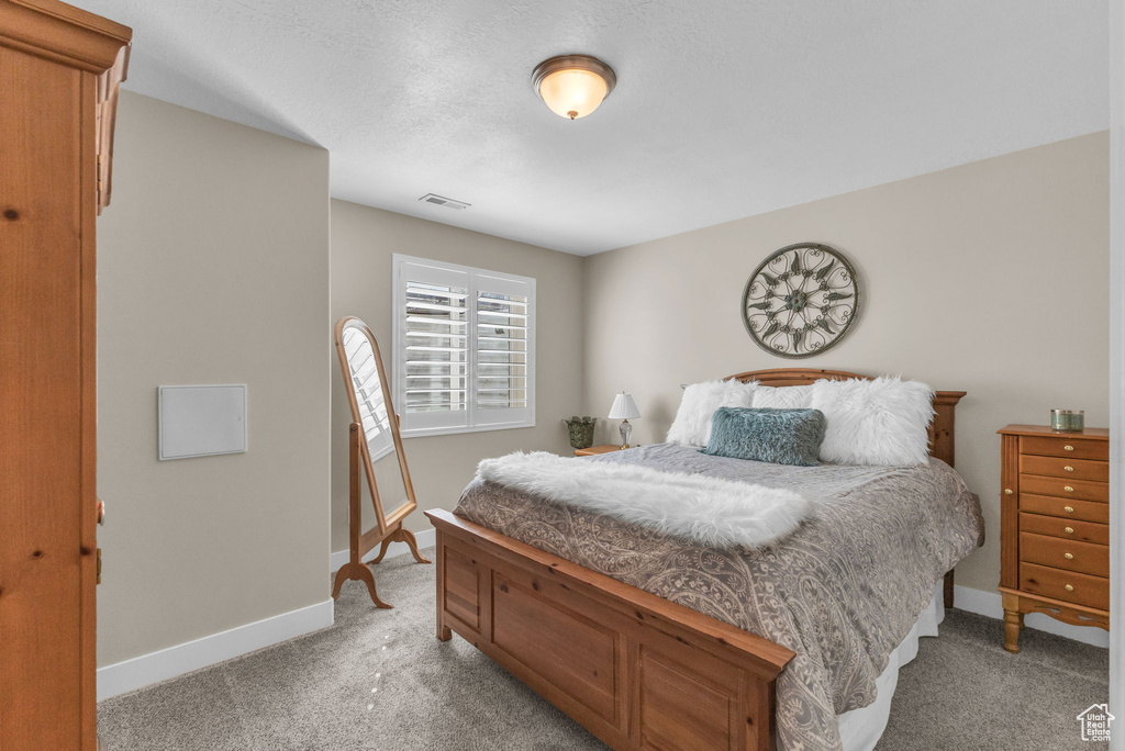 Bedroom with light carpet and baseboards