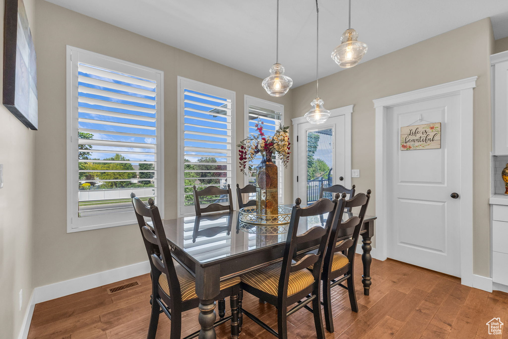 Dining room featuring healthy amount of natural light, light wood-type flooring, and baseboards