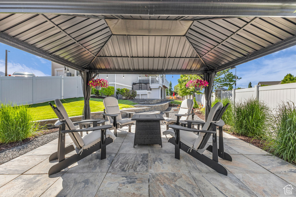 View of patio with a gazebo and an outdoor fire pit