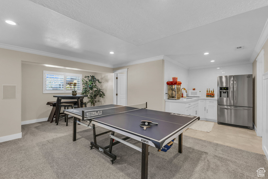 Playroom featuring recessed lighting, crown molding, light carpet, and baseboards