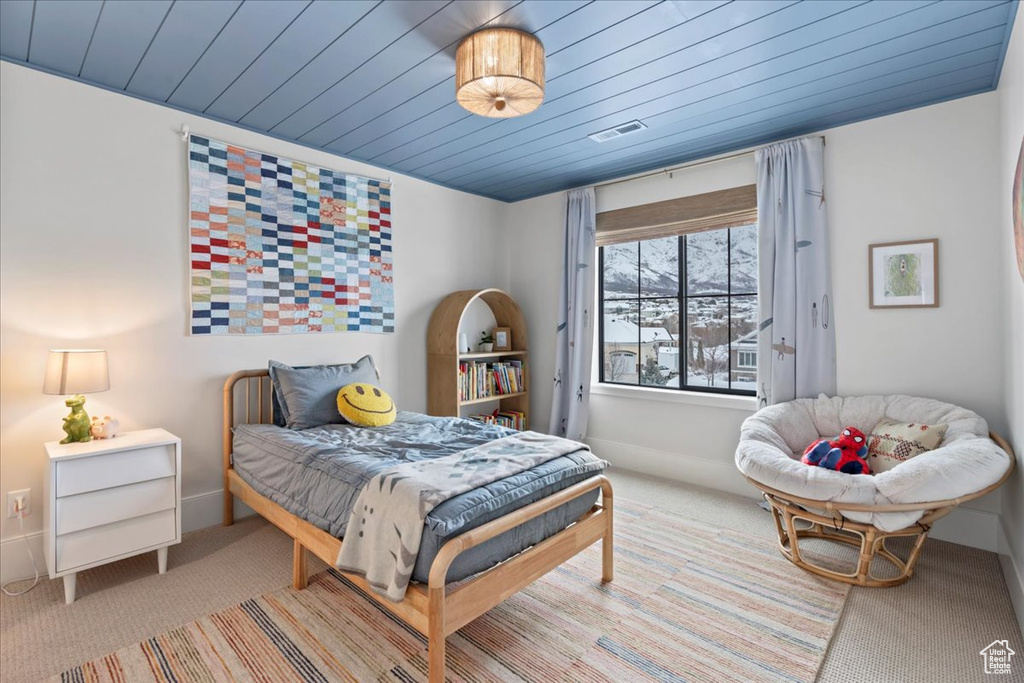 Carpeted bedroom with wooden ceiling