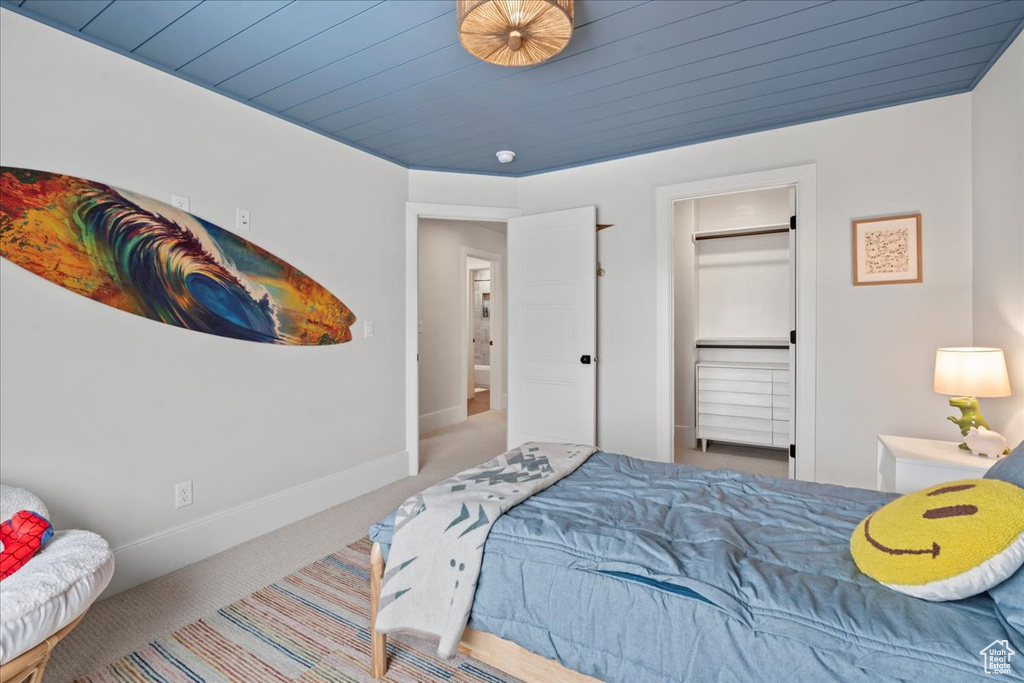 Bedroom featuring carpet flooring and baseboards