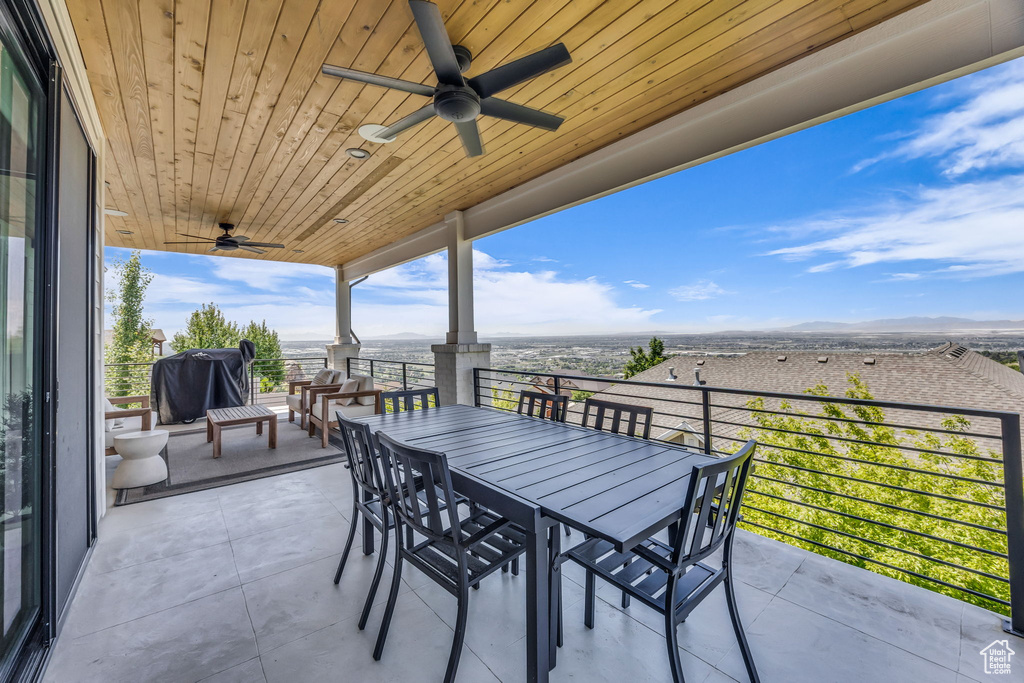 View of patio with a ceiling fan, outdoor dining space, and grilling area