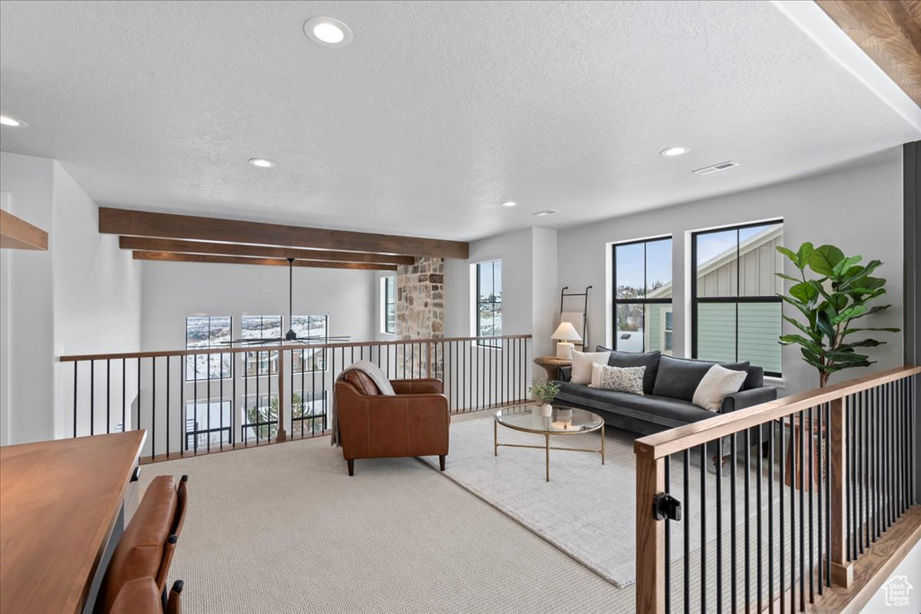 Living area featuring recessed lighting, carpet, and a textured ceiling