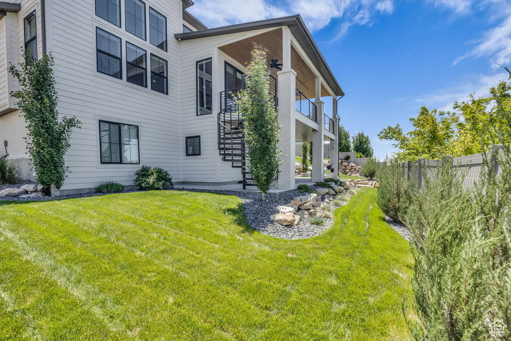 View of side of property featuring stairway and a patio area