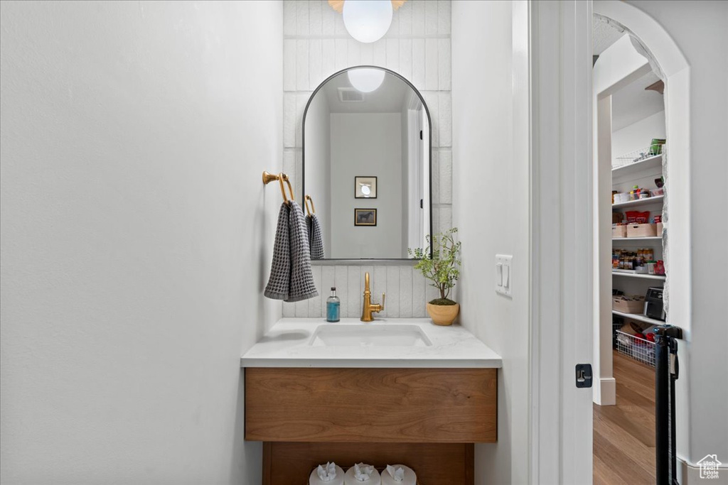 Bathroom featuring vanity and wood finished floors